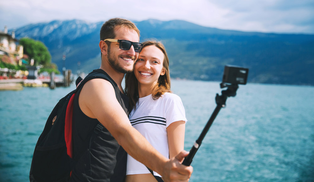 Couple using GoPro camera on holiday